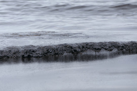 crude oil spill on the beach