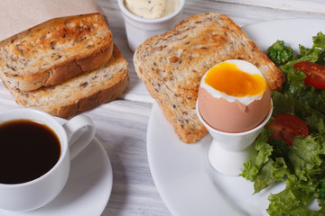 Vitamin breakfast. Boiled egg with toast and salad.