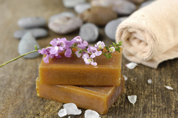 grey stones and flower on old wooden