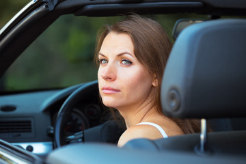 Caucasian woman in a cabriolet