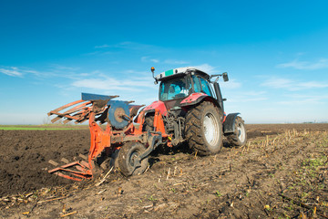 Fototapeta premium Tractor plowing field