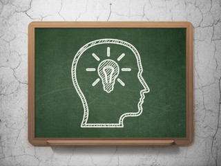 Education concept: Head With Lightbulb on chalkboard background