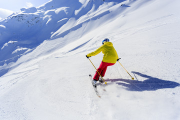 Skiing, skier, winter sport - woman skiing downhill