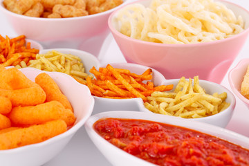 Potato, corn and wheat chips in bowls