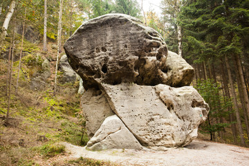 Obraz premium Large natural rock against trees