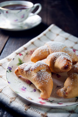 Croissant with jam and tea for breakfast