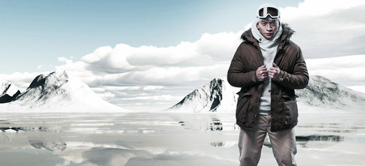 Asian winter fashion man in snow mountain landscape. Wearing woo