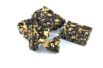 Honey bars with black sesame seeds isolated on white