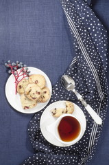 Porcelain dishes and cookies with cranberries