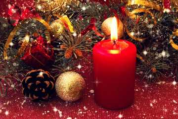 red candle and other christmas decorations