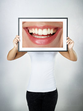 Woman holding picture with a big smile