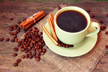 hot cup of coffee, cinnamon and coffee beans - 58204408