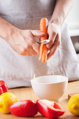 man hands peeling carrot