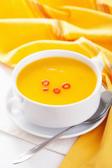pumpkin soup in white bowl