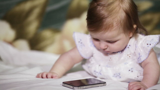 Baby listens smartphone