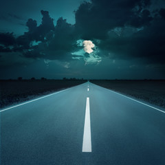 Night driving on an empty road to the moon