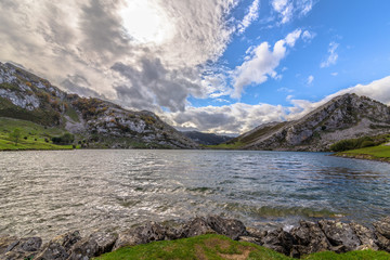 Enol lake surrounded by mountains on a cloudy day in Asturias