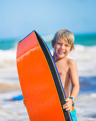 Happy Young boy having fun at the beach on vacation,