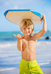 Happy Young boy having fun at the beach on vacation,