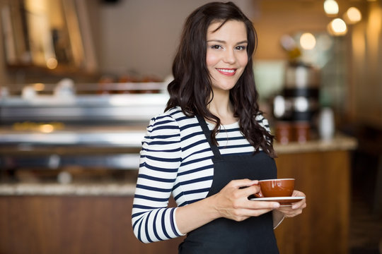 Beautiful Waitress Holding Coffee Cup In Cafeteria