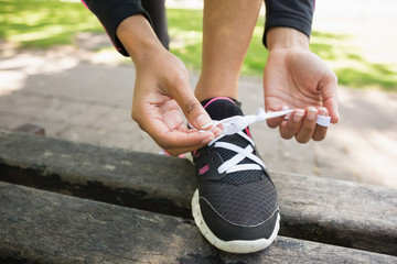 Close up of a sporty young woman wearing shoes in park