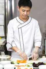 Japanese chef with a plate of sushi