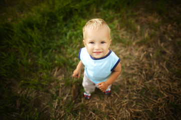 sad little boy portrait in high grass