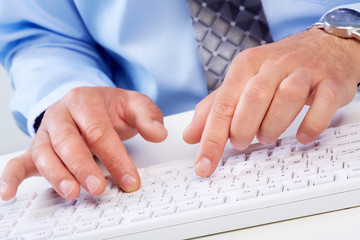Hands with a computer keyboard.