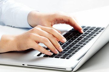 Fototapeta na wymiar Hands with laptop computer keyboard.