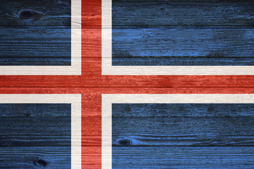 Iceland Flag painted on old wood plank background.