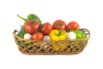 Assorted ripe vegetables in wicker basket isolated closeup