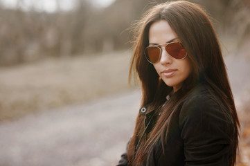 Young woman in sunglasses outdsoor portrait