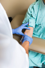 Male Doctor Drawing Blood From Patient's Arm