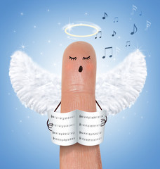 Singing angel on finger - 58227844