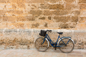 Fototapeta na wymiar Bicycle in historical Ciutadella stone wall at Balearics