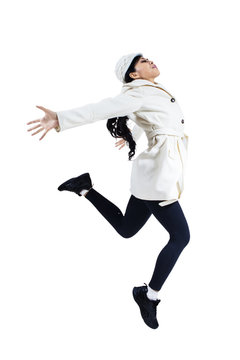 Woman jumping with winter coat