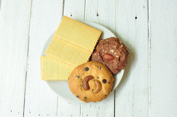 Various crackers and cookies on wooden table.
