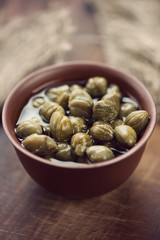 Vertical shot of ceramic bowl with pickled capers