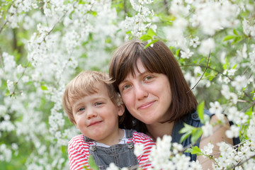 Happy mother with toddler  in spring