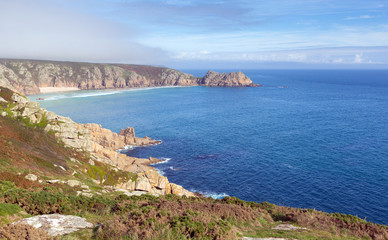 Cornwish coast in autumn mist and blue sky near Minack