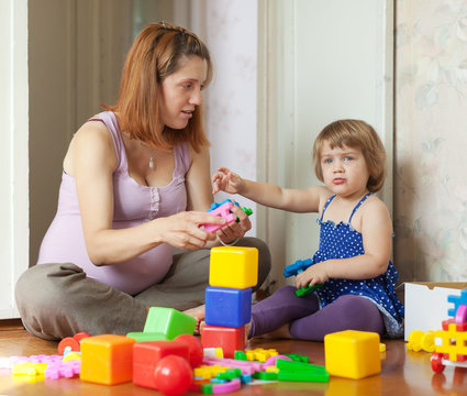 mother plays with child in home