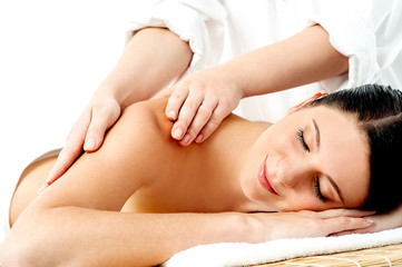Obraz na płótnie Canvas Relaxed young woman enjoying body massage