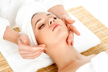 Naklejka premium Woman getting facial massage in spa salon