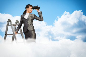 businesswoman looking through binoculars