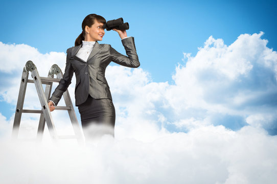 businesswoman looking through binoculars - Powered by Adobe