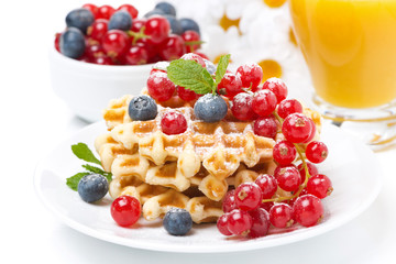 delicious breakfast with waffles, berries and orange juice