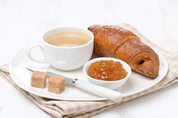 Fresh coffee, orange jam and croissant, selective focus