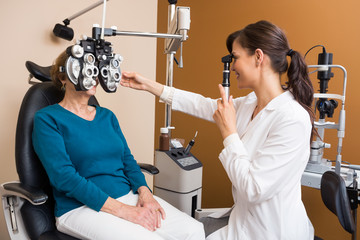 Optometrist Examining Senior Woman's Eyes