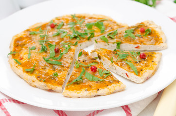 sliced ​​chicken pizza with tomato sauce, cheese and herbs