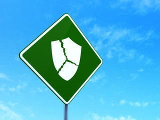 Protection concept: Broken Shield on road sign background